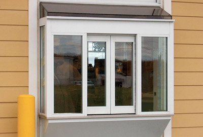 Framed sliding service window on a commercial building